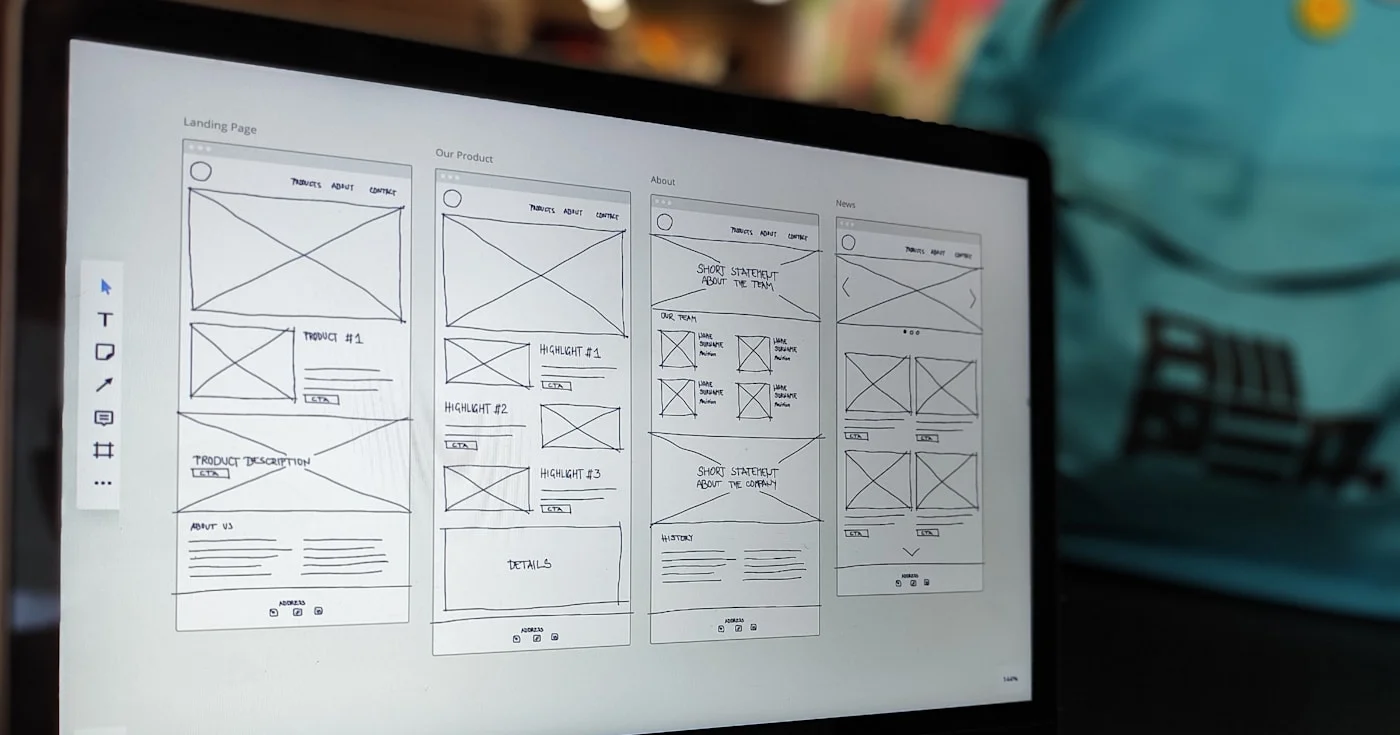 Website wireframes on a laptop screen during product UI design